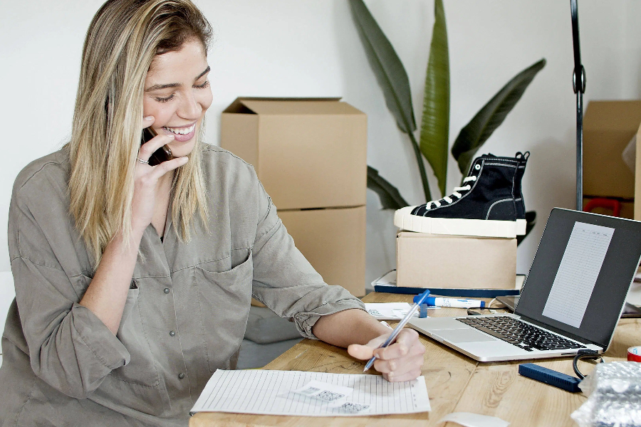 A happy businesswoman is managing her online store orders